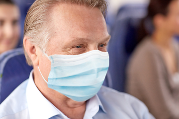 Image showing senior passenger in mask in travel bus or airplane