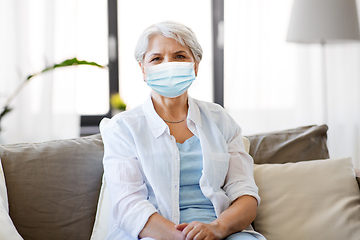 Image showing senior woman in protective medical mask at home