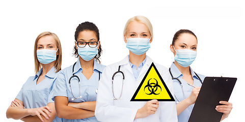 Image showing female doctor and nurses with biohazard sign