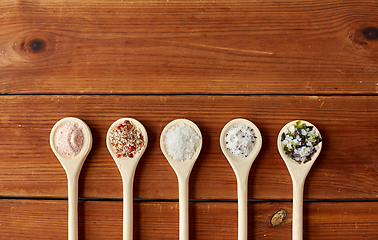 Image showing spoons with salt and spices on wooden table