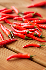 Image showing red chili or cayenne pepper on wooden boards