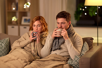 Image showing sick young couple drinking hot tea at home