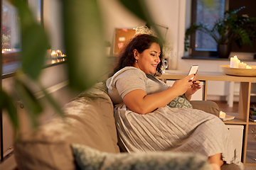 Image showing woman with smartphone at home in evening