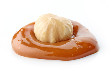 Image showing hazelnut in melted caramel drop