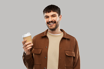 Image showing smiling young man with takeaway coffee cup