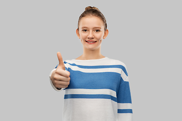 Image showing smiling teenage girl showing thumbs up