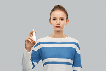 Image showing teenage girl with nasal spray over grey background