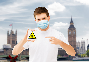 Image showing man in mask with coronavirus sign in england