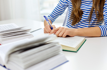 Image showing close up of student girl writing to exercise book