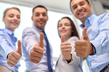 Image showing happy smiling business team showing thumbs up