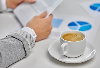 Image showing hands of businesswoman and cup of coffee at office