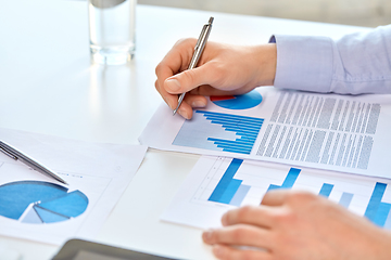 Image showing close up of businessman's hands with charts