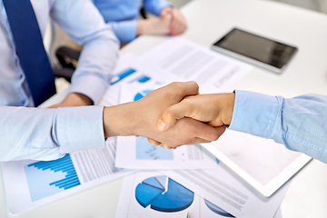 Image showing close up of businessmen making handshake at office