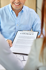 Image showing realtor showing contract document to customers