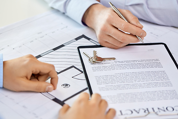 Image showing hands signing property purchase contract at office