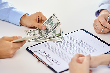 Image showing close up of hands with dollar money and contract