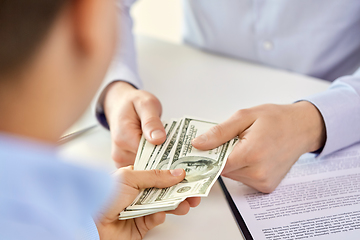 Image showing close up of hands with dollar money and contract