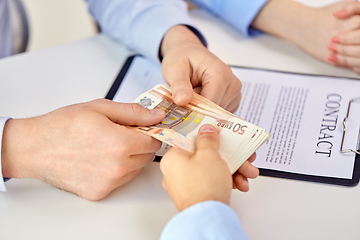 Image showing close up of hands with euro money and contract