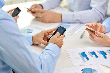 Image showing businesspeople with smartphones at office