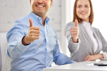 Image showing happy smiling business team showing thumbs up