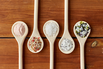 Image showing spoons with salt and spices on wooden table