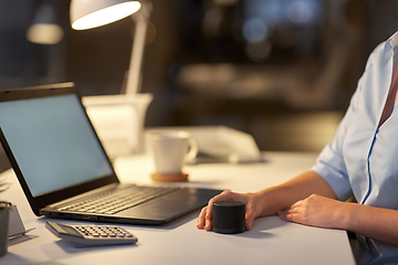 Image showing close up of hand with smart speaker at office