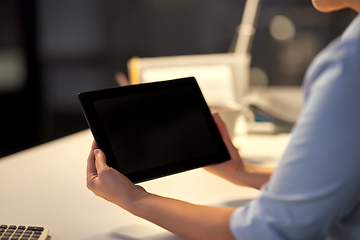 Image showing businesswoman with tablet computer at night office