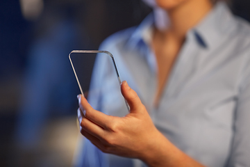 Image showing close up of hand with transparent smartphone