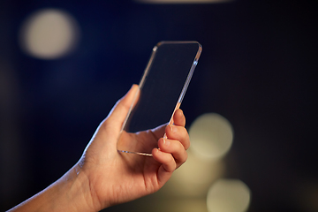 Image showing close up of hand with transparent smartphone