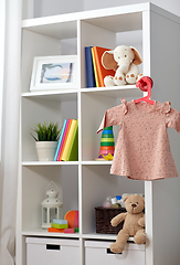 Image showing kid's room interior with bookcase and baby dress