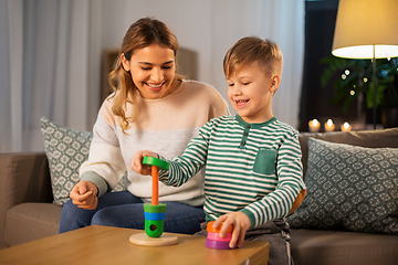 Image showing mother and son playing with toy pyramid at home