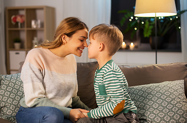 Image showing happy mother and son touching noses at home