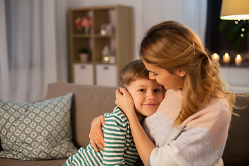 Image showing happy smiling mother and son hugging at home