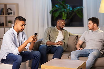 Image showing man using smartphone while friends talking at home