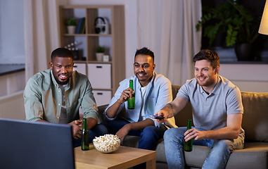 Image showing happy male friends with beer watching tv at home