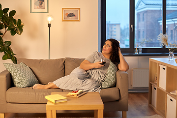 Image showing happy woman drinking red wine at home in evening