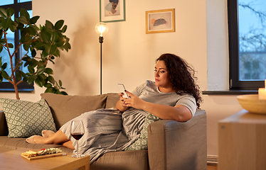 Image showing woman with smartphone at home in evening