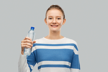 Image showing smiling teenage girl with bottle of water