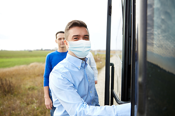 Image showing male passenger in medical mask boarding travel bus