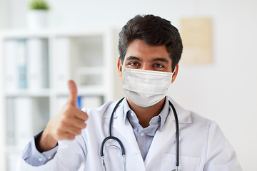 Image showing doctor in medical mask at clinic showing thumbs up