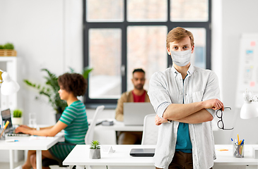 Image showing man with glasses in medical mask at office