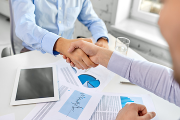 Image showing close up of businessmen making handshake at office