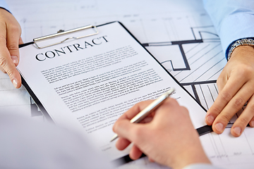 Image showing customer signing contract document at office