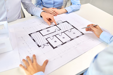 Image showing close up of architects with blueprint at office