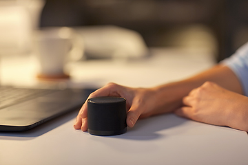 Image showing close up of hand with smart speaker at office