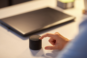 Image showing close up of hand with smart speaker at office