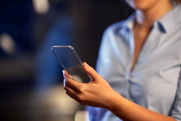 Image showing close up of hand with transparent smartphone