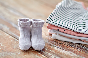 Image showing close up of baby clothes on wooden table