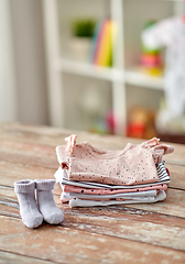 Image showing baby clothes on wooden table at home