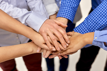 Image showing close up of people stacking hands